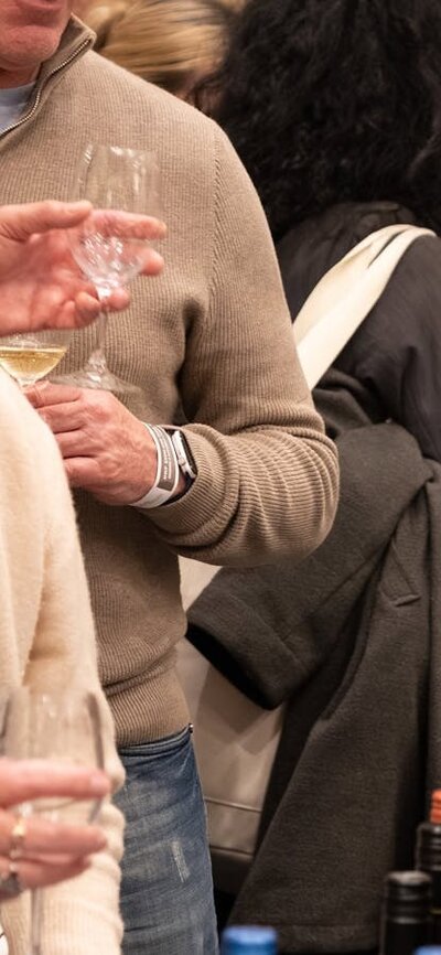 People listening to a steward talk about the wine they are about to taste. Wine Tasting