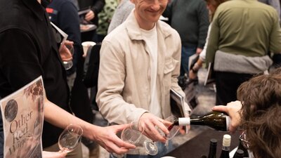 Young men having a wine poured into their glass. Young men having wine poured into their glass