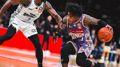 Sydney Kings player and opponent on court