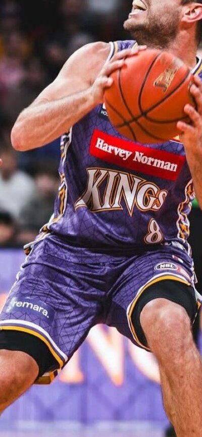 Sydney Kings player and opponent on court