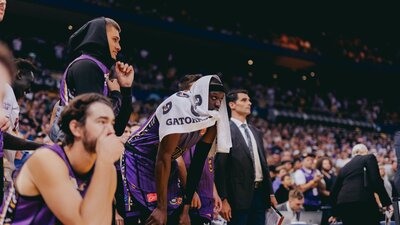 Sydney Kings players watch a game from the bench