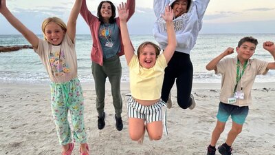 Access Adventure Club participants, with children jumping and smiling