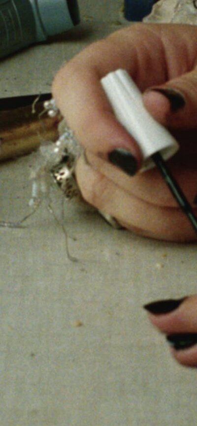 NFSA Restores: Sweetie + Q&A woman painting her nails with reflection of her face in a mirror