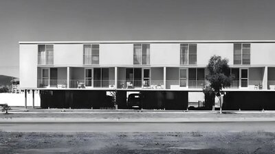 Heritage Series Maisonettes A black and white photo of the Northbourne Ave Flats in brutalist style from the road