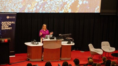 Professor Misty Jenkins giving a lecture at a podium in a lecture theatre