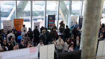 Overhead shot of expo with attendees and several booths visible