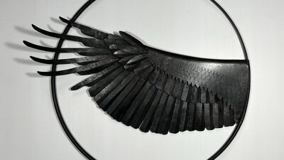 A forged steel sculpture of a raven's wing.