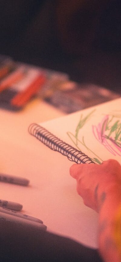 Person wearing hi-vis drawing using textas