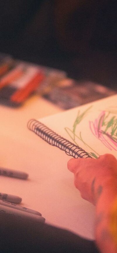 Person wearing hi-vis drawing using textas