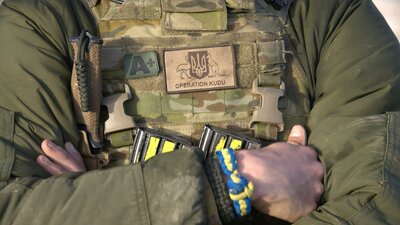 Soldier with operation Kudu patch and blue and yellow friendship braclelet