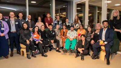 Out for Australia supports LGBTQIA+ people at the formative stages of their careers with mentoring. A large group of people posing for a photograph