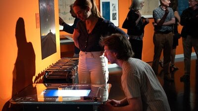 Visitors playing Guide Star, an arcade game made for the exhibition