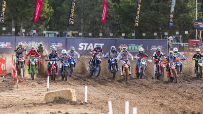 A pack of riders take off from the ProMX MX1 start line