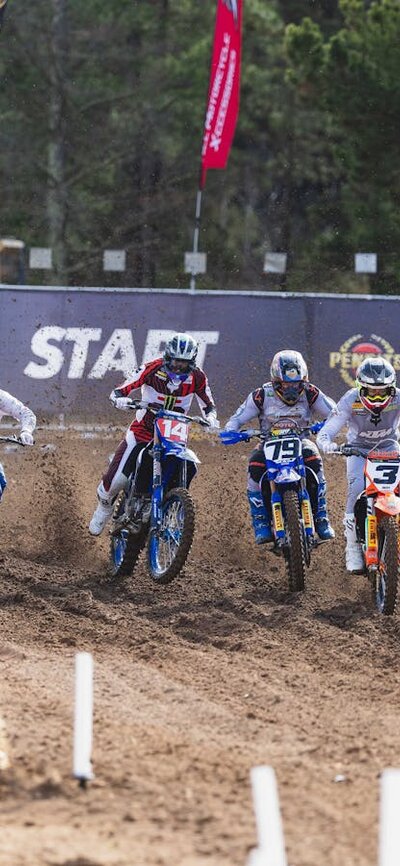 A pack of riders take off from the ProMX MX1 start line