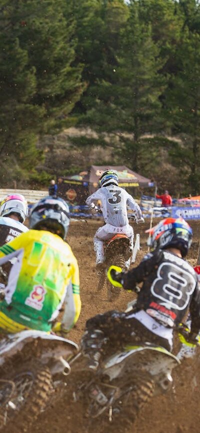 A pack of riders round a corner into the Holeshot gate