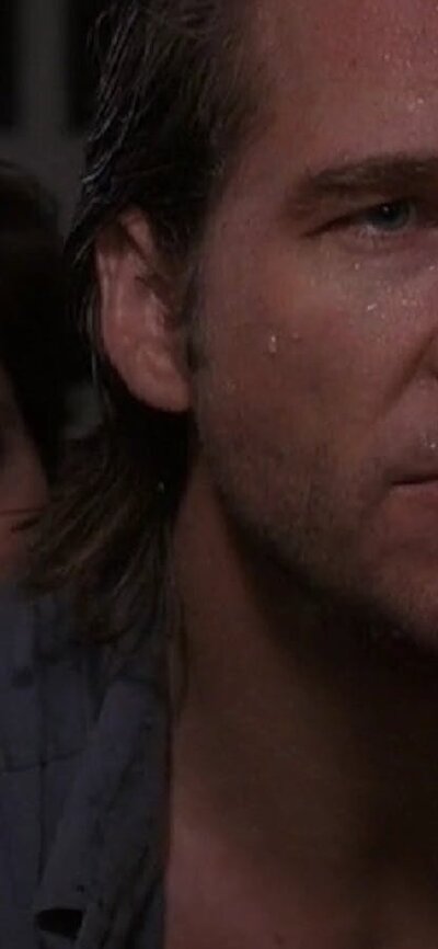 Fearless (1993|M) low lighting photo of man looking past camera and woman standing close behind his shoulder