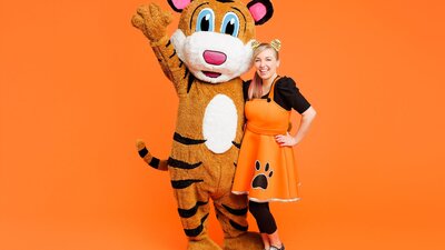 A photo of Pevan & Sarah on an orange background