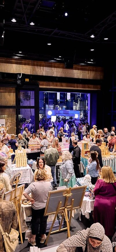 Market stalls set up with large crowds wandering around
