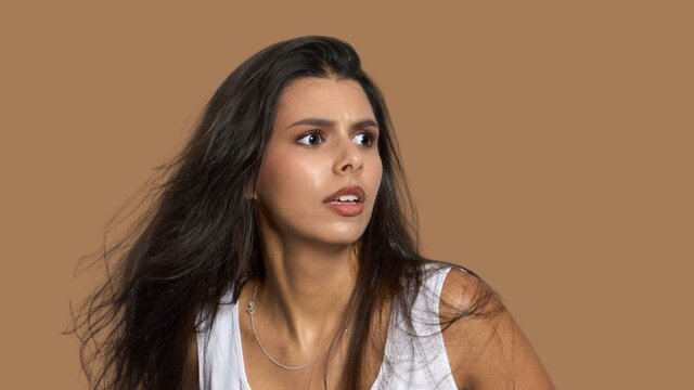 Picnic at Hanging Rock Young woman in white dress looks scared off camera