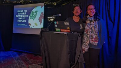 Scientists smiling at the camera, after presenting their research at Adelaide Pint AU event.