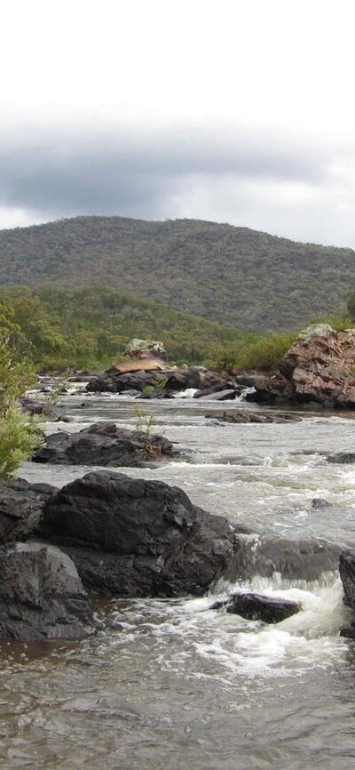The Murrumbidgee River A picture of a waterwatch with rocks and hills in the background