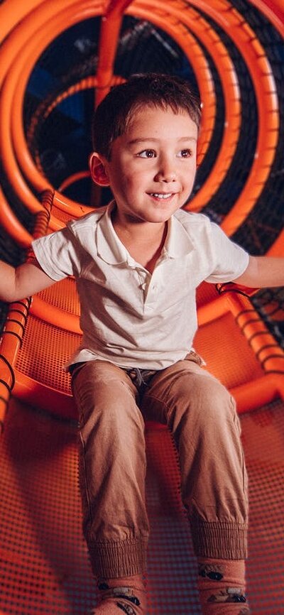 Boy sitting on indoor playground