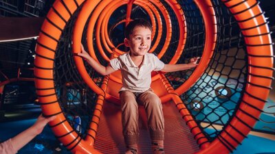 Boy sitting on indoor playground