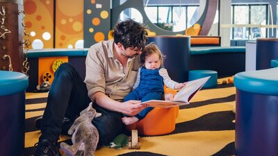 Dad reads to her young daughter