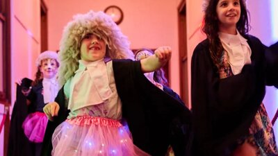 Kids dressed up in costumes walking down a hallway at Old Parliament House