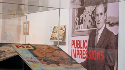 A view of Sidey Nolan Public Impressions wall decal in exhibition with Pix Magazine in front