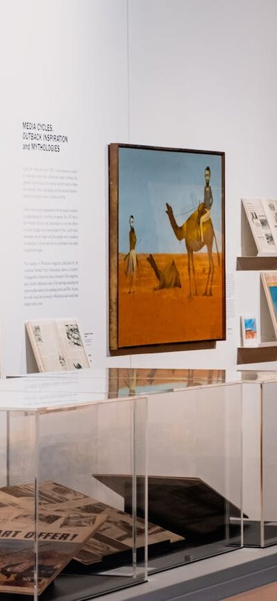 View of multiple Sidney Nolan paintings and vitrines with articles on Nolan