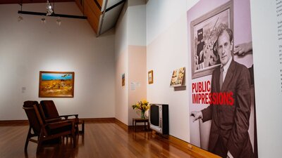 View of multiple Sidney Nolan paintings and vitrines with articles on Nolan