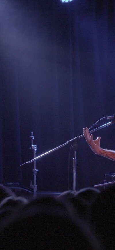 Still of band members playing on stage at a concert