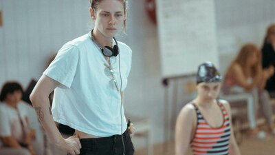 The Chronology of Water, 7:00 PM Thu, Sep 3, 2026 Rated R 18+ Woman stands with headphones and white t shirt with hands in pockets looking forlorn