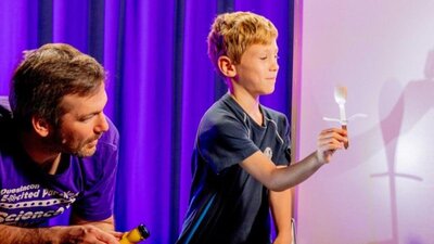 A man and a young boy exploring light in Science Time