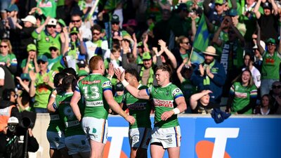 Canberra Raiders players and fans celebrate a try.
