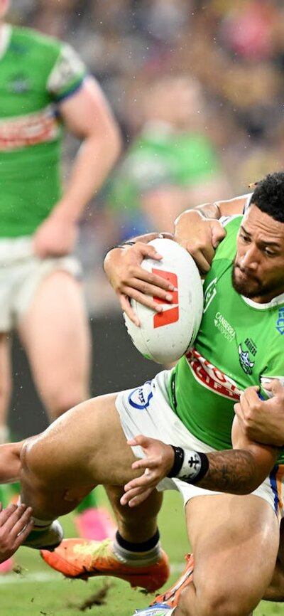 Canberra Raiders player Simi Sasagi being tackled.