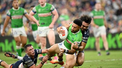 Canberra Raiders player Simi Sasagi being tackled.