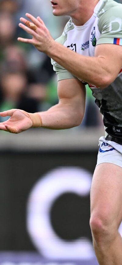 Canberra Raiders player Ethan Strange passing the ball.