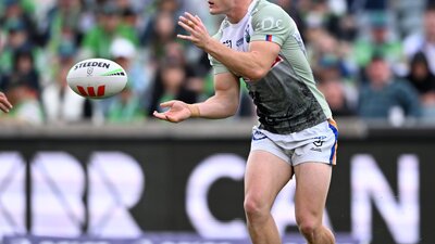 Canberra Raiders player Ethan Strange passing the ball.