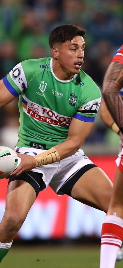 Canberra Raiders player Joseph Tapine passing the ball.