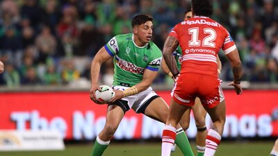 Canberra Raiders player Joseph Tapine passing the ball.