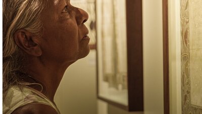 Close up of woman looking intently at an artwork