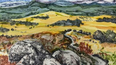 monoprint of a landscape with mountains and boulders with a blue sky