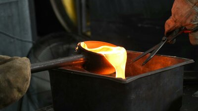 sandcasting ladle of hot glass