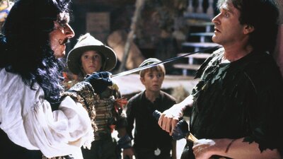 A pirate points a sword at a scared man with scared children in background