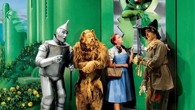 The Wizard of Oz (1939) tin man, lion, young woman in blue dress and a man made of straw huddle together
