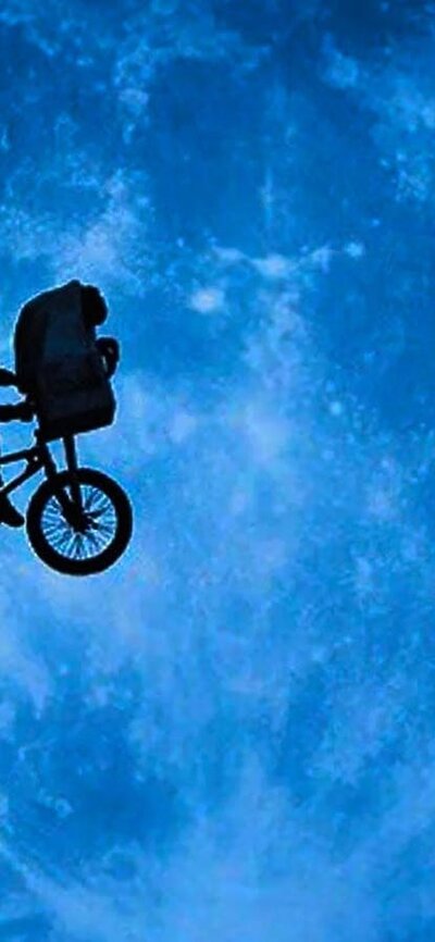 E.T. the Extra-Terrestrial, 2:00 PM Thu, Jul 9, 2026 Rated PG A shadow image of a person in a cape on a bike cycling across the sky in front of a large planet
