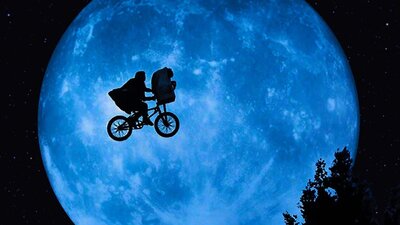 E.T. the Extra-Terrestrial, 2:00 PM Thu, Jul 9, 2026 Rated PG A shadow image of a person in a cape on a bike cycling across the sky in front of a large planet