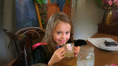 Young witch drinking a QBrew